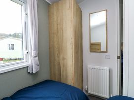 A bedroom with a bed and wardrobe at Valley 36 in Kingsbridge