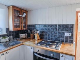 A kitchen with stove, oven, sink, and kitchen cabinet at 2 Oak Tree Cottages Marshwood Nr. Hawkchurch