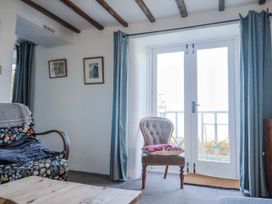 A living room with a sofa and chair at 2 Oak Tree Cottages in Marshwood Nr. Hawkchurch