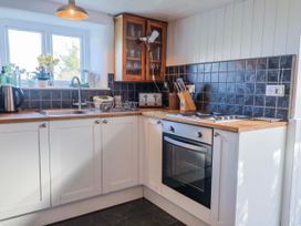 A kitchen with a sink and oven at 2 Oak Tree Cottages Marshwood Nr. Hawkchurch