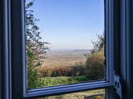 A view of hills and trees through a window at 2 Oak Tree Cottages Marshwood Nr. Hawkchurch
