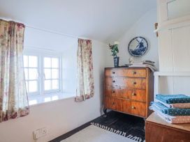 A bedroom with a window and a chest of drawers at 2 Oak Tree Cottages Marshwood Nr. Hawkchurch