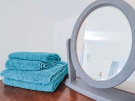 A stack of towels and a mirror at 2 Oak Tree Cottages in Marshwood Nr. Hawkchurch