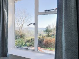 A window with curtains showing a view at 2 Oak Tree Cottages Marshwood Nr. Hawkchurch