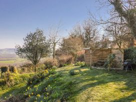 A garden with a bench and table at 2 Oak Tree Cottages, Marshwood Nr. Hawkchurch