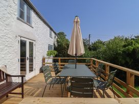 An outdoor dining area with table and chairs at 2 Oak Tree Cottages in Marshwood Nr. Hawkchurch