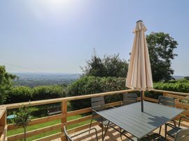 An outdoor seating area with a table and chairs at 2 Oak Tree Cottages Marshwood Nr. Hawkchurch