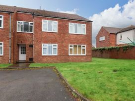 A brick house with a front door and grass in the outdoor area at Flat 1, 40 Hinderwell Lane