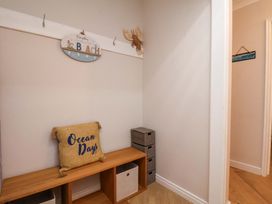 A hallway with a bench and storage boxes at Flat 1, 40 Hinderwell Lane