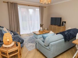 A living room with a sofa and television at Flat 1, 40 Hinderwell Lane