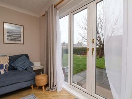 A living room with a sofa and window at Flat 1, 40 Hinderwell Lane