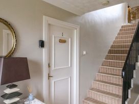 A hallway with stairs and a door at Flat 1, 40 Hinderwell Lane