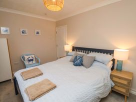 A bedroom with a bed and side table at Flat 1, 40 Hinderwell Lane