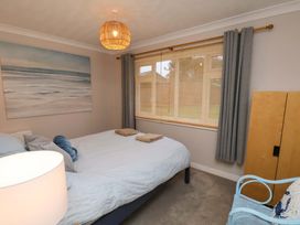 A bedroom with a bed and wardrobe at Flat 1, 40 Hinderwell Lane