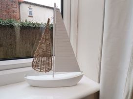 A model sailboat on a window sill at Flat 1, 40 Hinderwell Lane