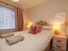 A bedroom with a bed and bedside table at Flat 1, 40 Hinderwell Lane