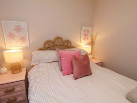 A bedroom with a bed and decorative pillows at Flat 1, 40 Hinderwell Lane