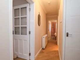 A hallway with a door and a mirror at Flat 1, 40 Hinderwell Lane