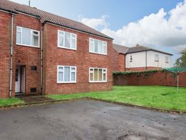 An outdoor area with a brick building and grass at Flat 1, 40 Hinderwell Lane