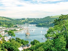 A view of a river with boats and hills at Capton Snug in Dartmouth