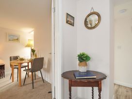 A dining area with a table and chairs at Casa Mia in Porthpean near St Austell