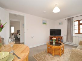 A living room with a television and coffee table at Casa Mia in Porthpean near St Austell