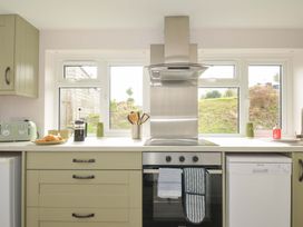A kitchen with an oven and dishwasher at Casa Mia near Porthpean