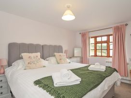 A bedroom with a double bed and a window at Casa Mia in Porthpean near St Austell