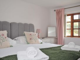A bedroom with a bed and window at Casa Mia in Porthpean near St Austell