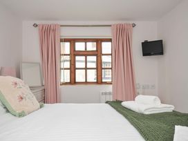 A bedroom with a bed and window at Casa Mia in Porthpean near St Austell