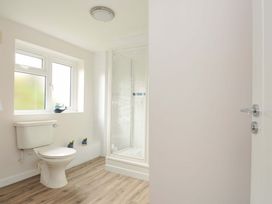 A bathroom with a shower and toilet at Casa Mia in Porthpean near St Austell