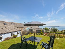 A garden with a table and chairs at Casa Mia in Porthpean near St Austell