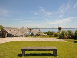 An outdoor area with a view of a body of water and buildings at Casa Mia in Porthpean near St Austell