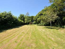 An open grassy area with trees at Casa Mia in Porthpean near St Austell