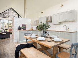 A kitchen with a dining table and chairs at Summerset Lodge