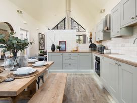 A kitchen with a dining table and chairs at Summerset Lodge