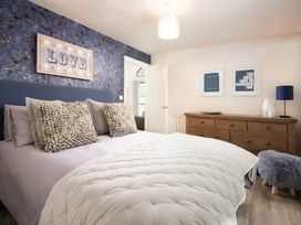 A bedroom with a bed and wall art at Summerset Lodge