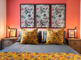 A bedroom with art on the walls and decorative pillows at Summerset Lodge