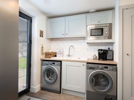 A laundry room with washing machine and sink at Summerset Lodge