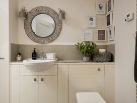 A bathroom with a sink and mirror at Summerset Lodge