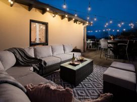 An outdoor seating area with a sofa and coffee table at Summerset Lodge