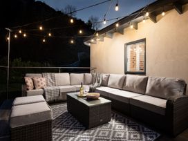 An outdoor seating area with a sofa and coffee table at Summerset Lodge