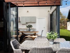 A dining area with a table and chairs at Summerset Lodge