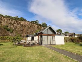 A house with a patio and pathway at Summerset Lodge in Bamburgh