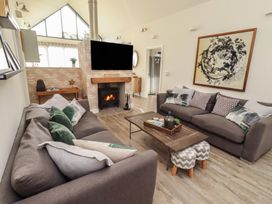 A living room with a fireplace and a sofa at Summerset Lodge in Bamburgh