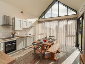 A kitchen with table and chairs at Summerset Lodge Bamburgh