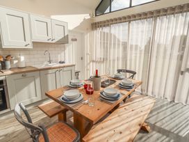 A kitchen with a dining table and chairs at Summerset Lodge in Bamburgh