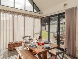 A dining room with a table set for a meal at Summerset Lodge Bamburgh