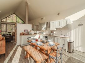 A kitchen with a dining table and chairs at Summerset Lodge in Bamburgh