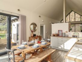 A dining area with a table and chairs at Summerset Lodge in Bamburgh